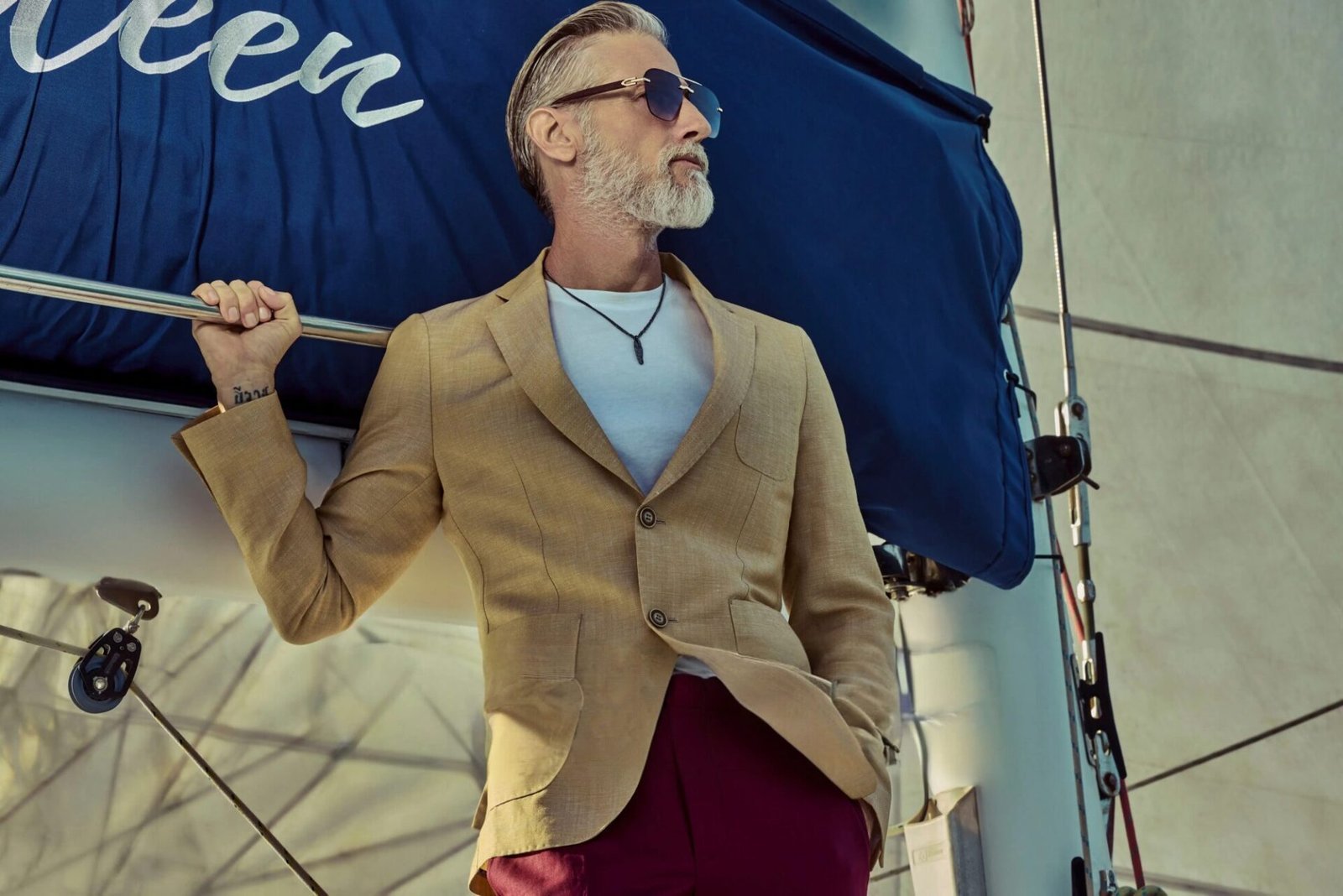 A VJs tailor adjusting a jacket during a fitting